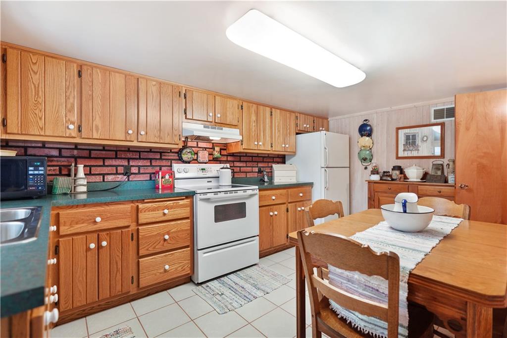 335 Spring Street Yukon, PA 15698 - Photo 4 of 24 THIS SPACIOUS, FULLY EQUIPPED KITCHEN IS SO PRETTY. THE GORGEOUS CABINETRY AND CERAMIC FLOORING WILL MAKE YOU PROUD TO CALL IT YOURS!