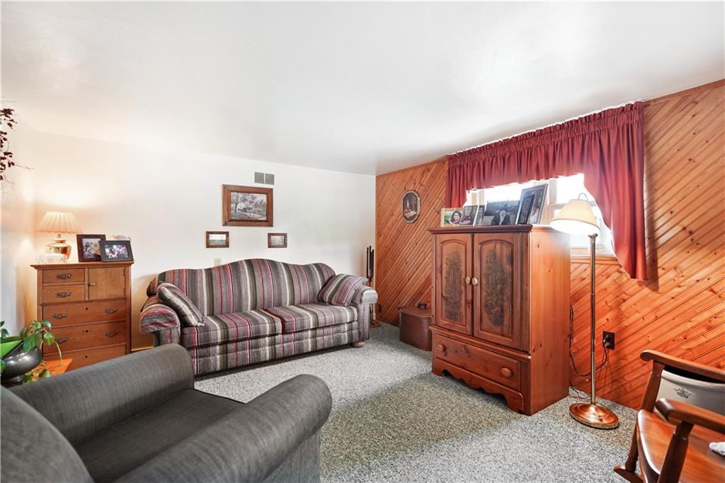 335 Spring Street Yukon, PA 15698 - Photo 7 of 24 COZY UP THIS WINTER IN YOUR NEW LIVING ROOM. THE WOOD WALLS ADD WARMTH AND A COZY FEEL!