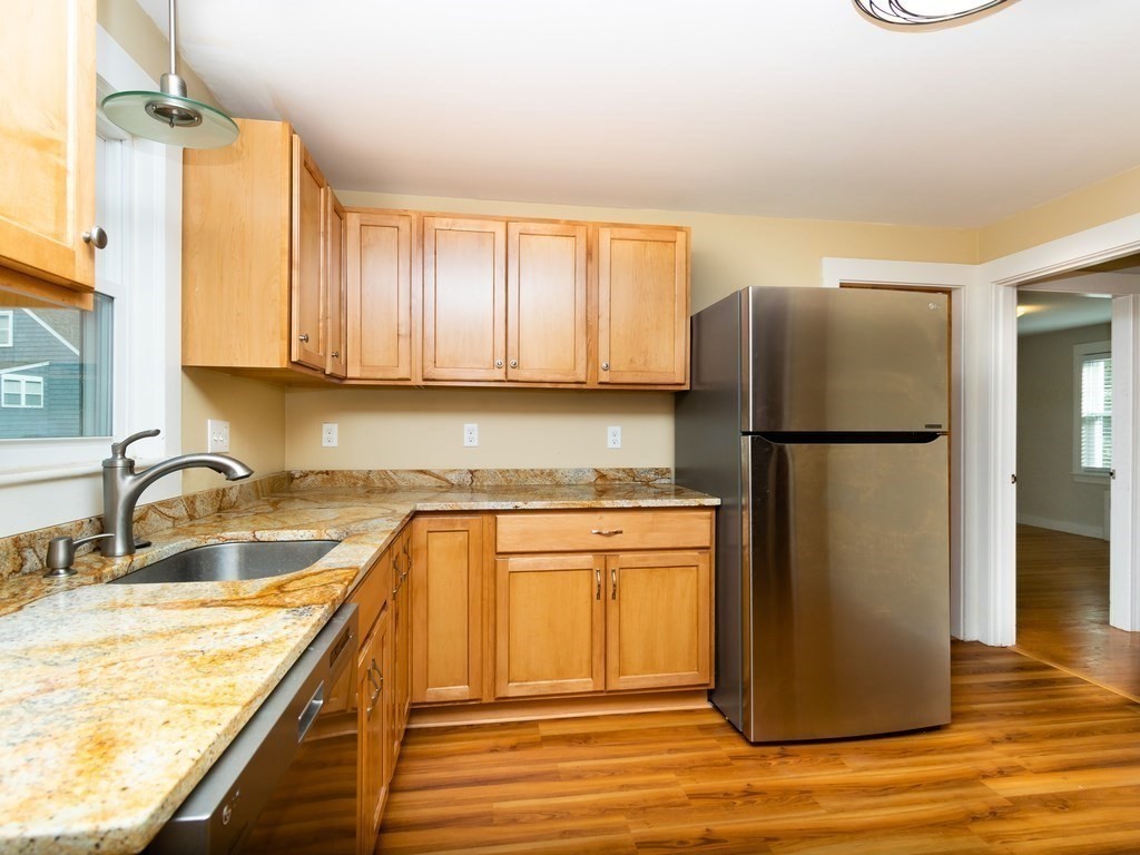 7 Mangano Court, Unit 2 Watertown, MA 02472 - Photo 3 of 14 a kitchen with a refrigerator sink and cabinets