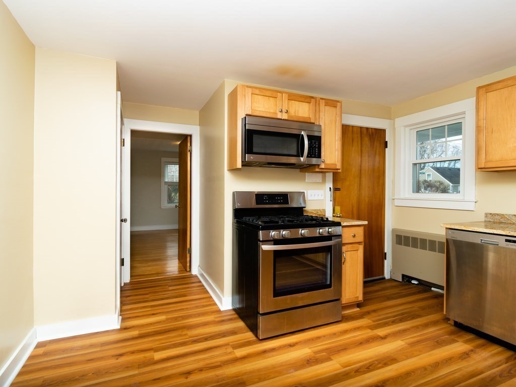 7 Mangano Court, Unit 2 Watertown, MA 02472 - Photo 4 of 14 a kitchen with stainless steel appliances a stove a microwave and sink