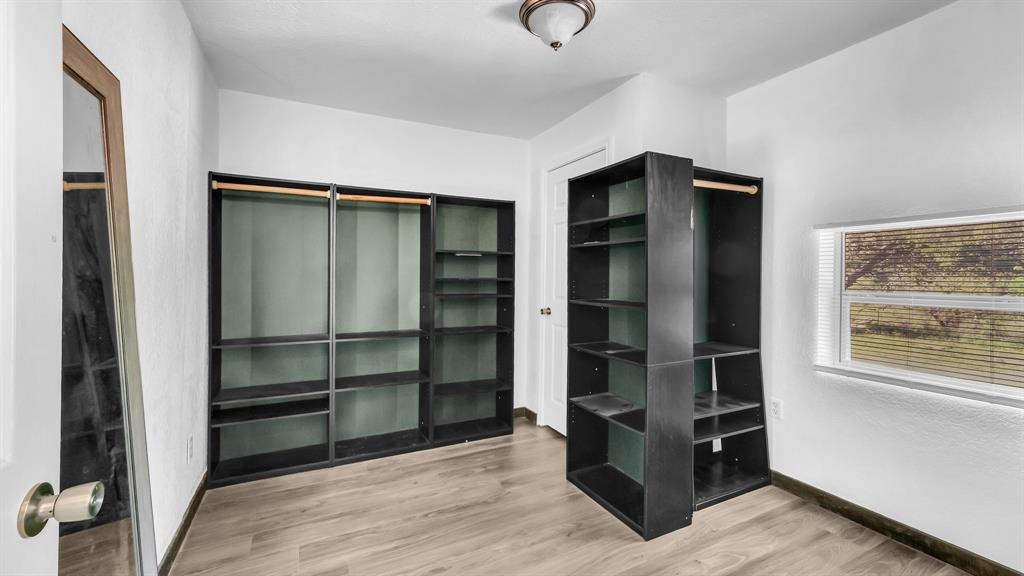 760 College Farm Road Stephenville, TX 76401 - Photo 16 of 32 a view of an empty room with cabinet and windows