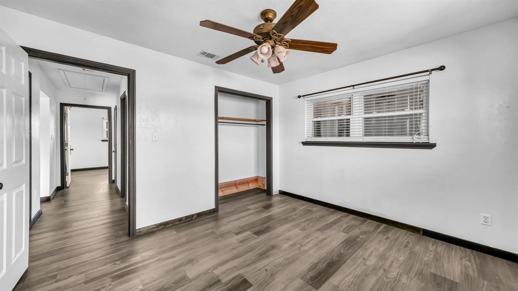 760 College Farm Road Stephenville, TX 76401 - Photo 19 of 32 a view of an empty room with wooden floor and a ceiling fan