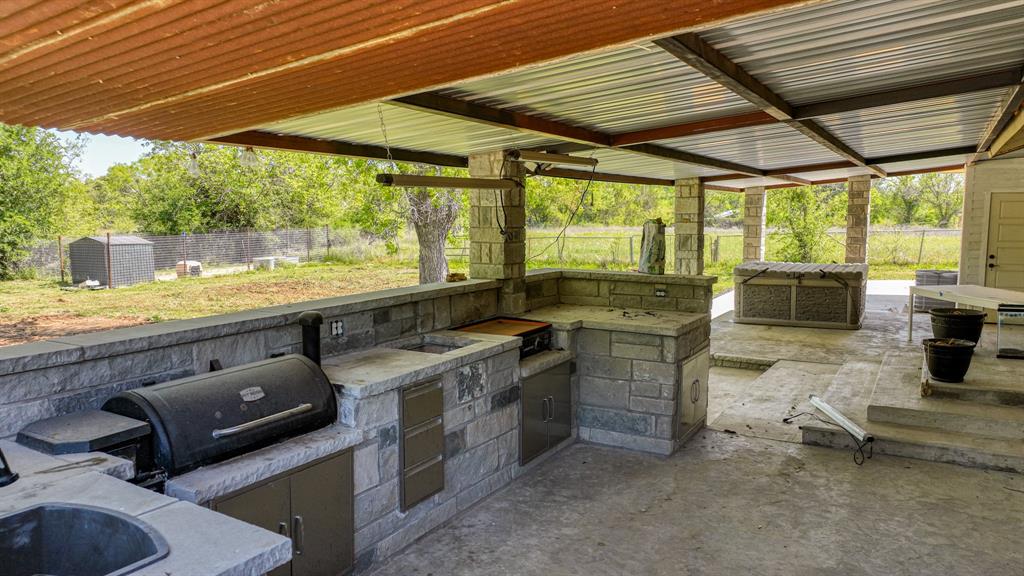 760 College Farm Road Stephenville, TX 76401 - Photo 25 of 32 a kitchen with a stove and a view of living room