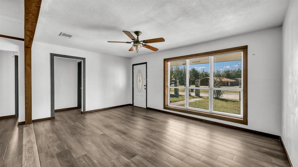 760 College Farm Road Stephenville, TX 76401 - Photo 5 of 32 a view of room with wooden floor and ceiling fan