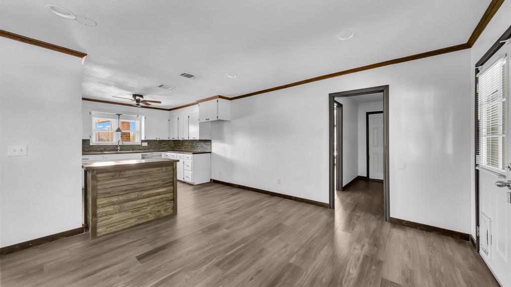 760 College Farm Road Stephenville, TX 76401 - Photo 8 of 32 a room with wooden floors and white walls