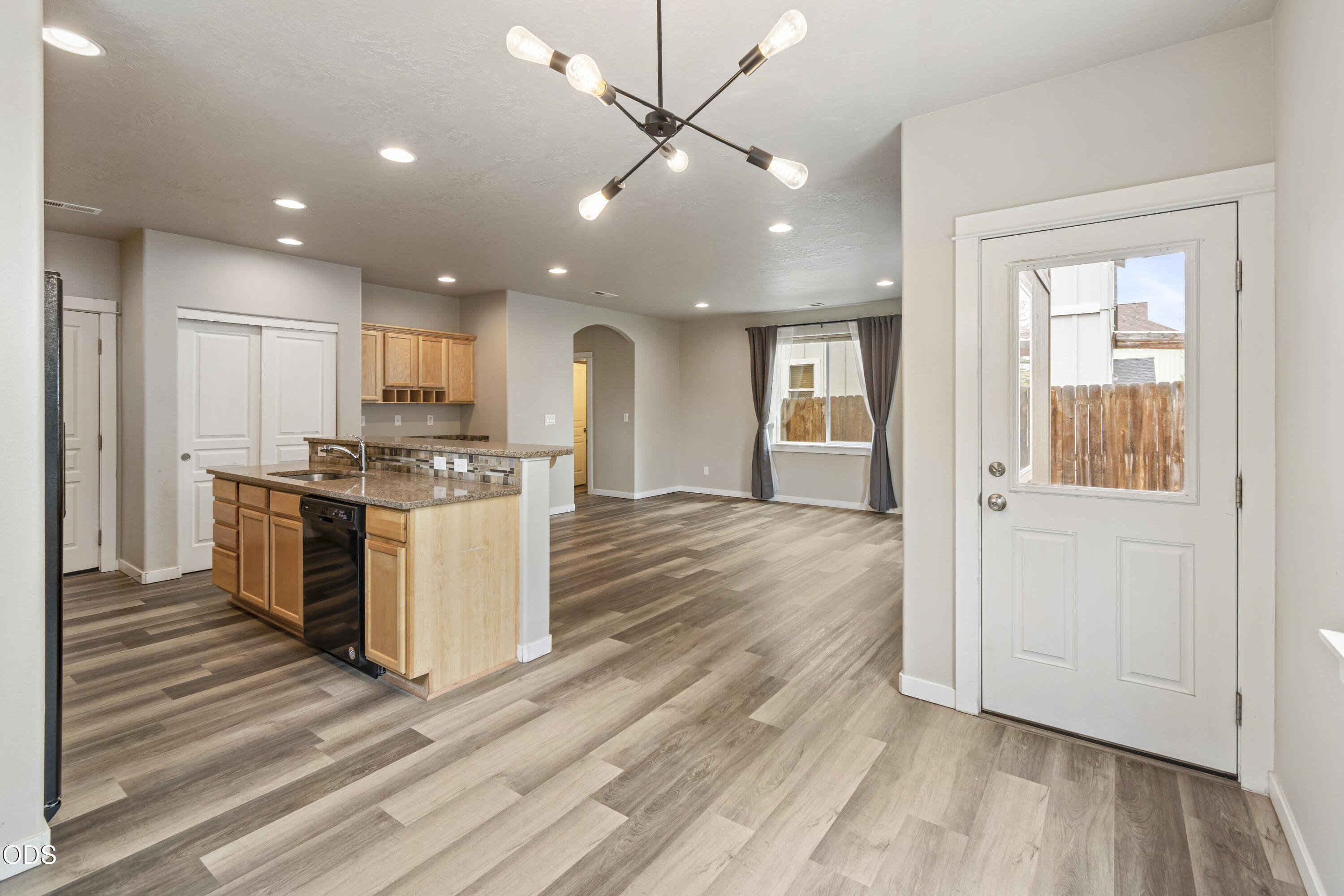 21332 Oconnor Way Bend, OR 97701 - Photo 2 of 33 a kitchen with kitchen island granite countertop a stove cabinets and wooden floor