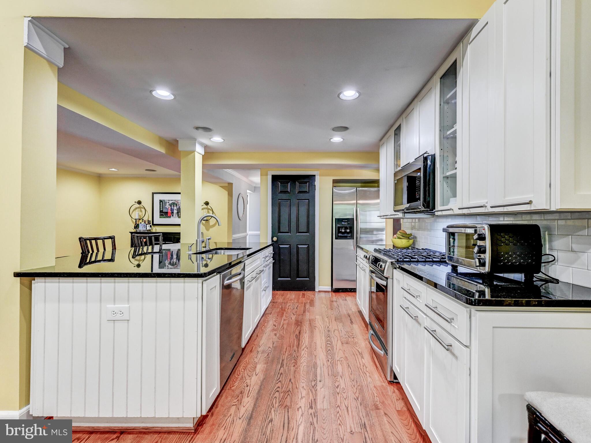 265 Hunters Ridge Road Lutherville-Timonium, MD 21093 - Photo 12 of 42 a kitchen with stainless steel appliances granite countertop a refrigerator a stove top oven a sink and dishwasher