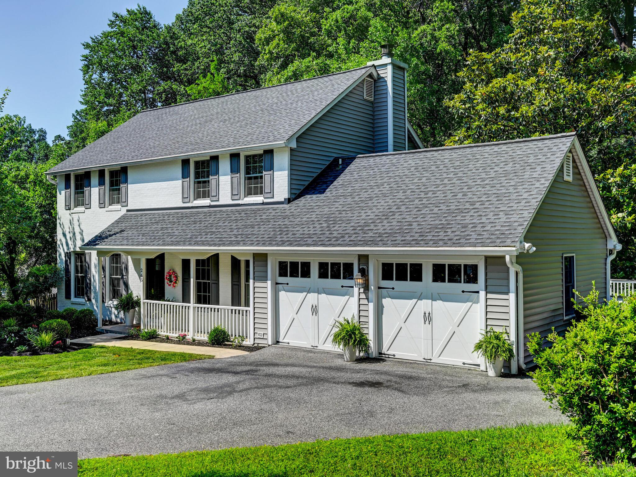 265 Hunters Ridge Road Lutherville-Timonium, MD 21093 - Photo 2 of 42 a front view of a house with a garden and plants