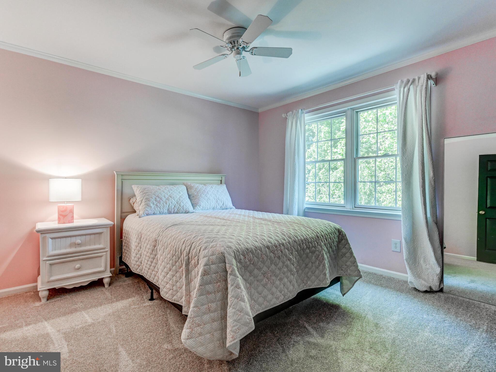 265 Hunters Ridge Road Lutherville-Timonium, MD 21093 - Photo 23 of 42 a spacious bedroom with a bed and a chandelier