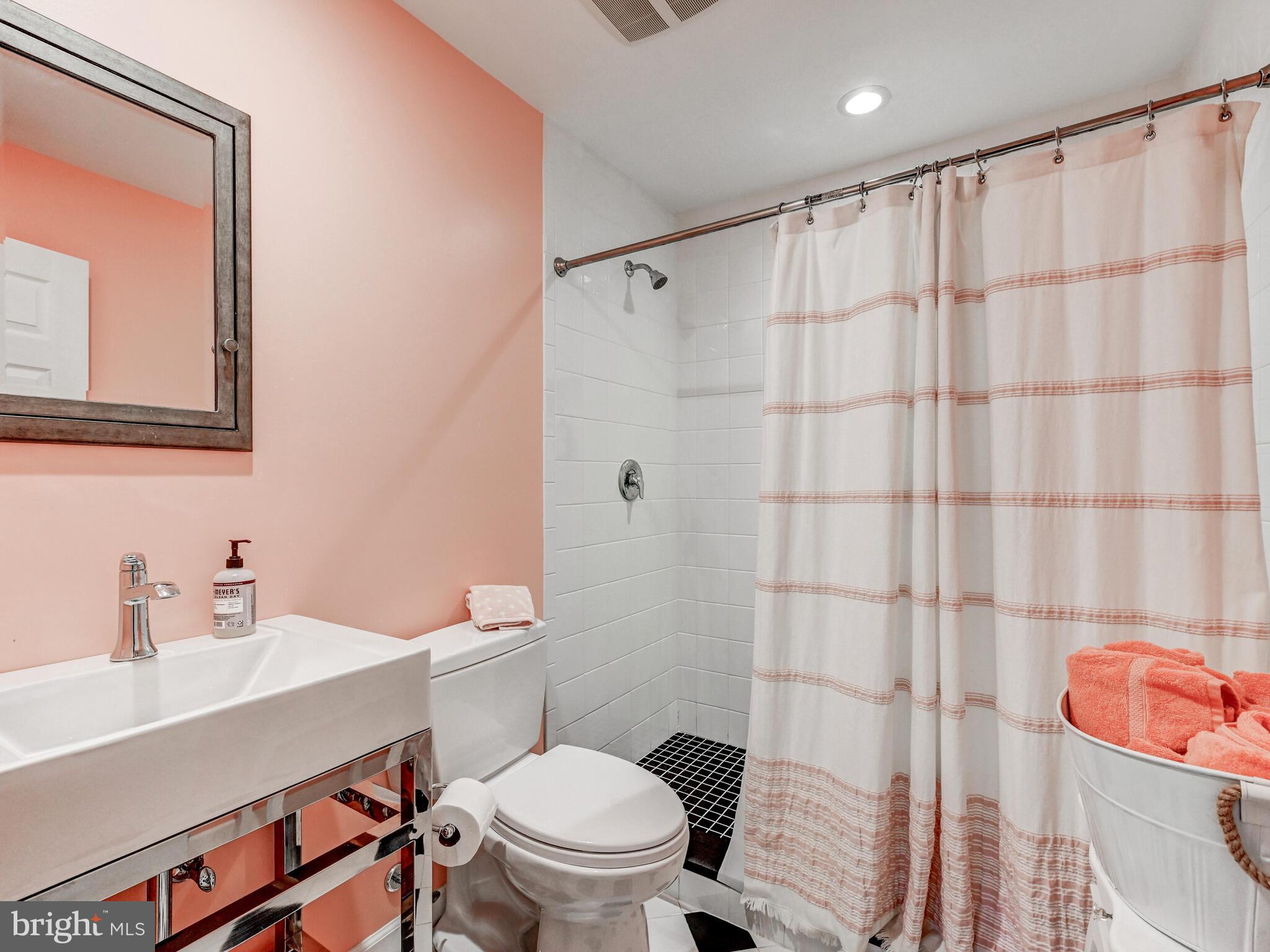 265 Hunters Ridge Road Lutherville-Timonium, MD 21093 - Photo 28 of 42 a bathroom with a sink a toilet and shower curtain