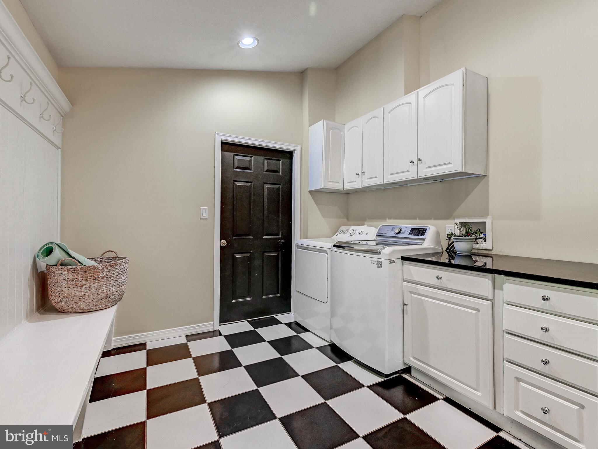 265 Hunters Ridge Road Lutherville-Timonium, MD 21093 - Photo 30 of 42 a kitchen with a checkered floor and white cabinets