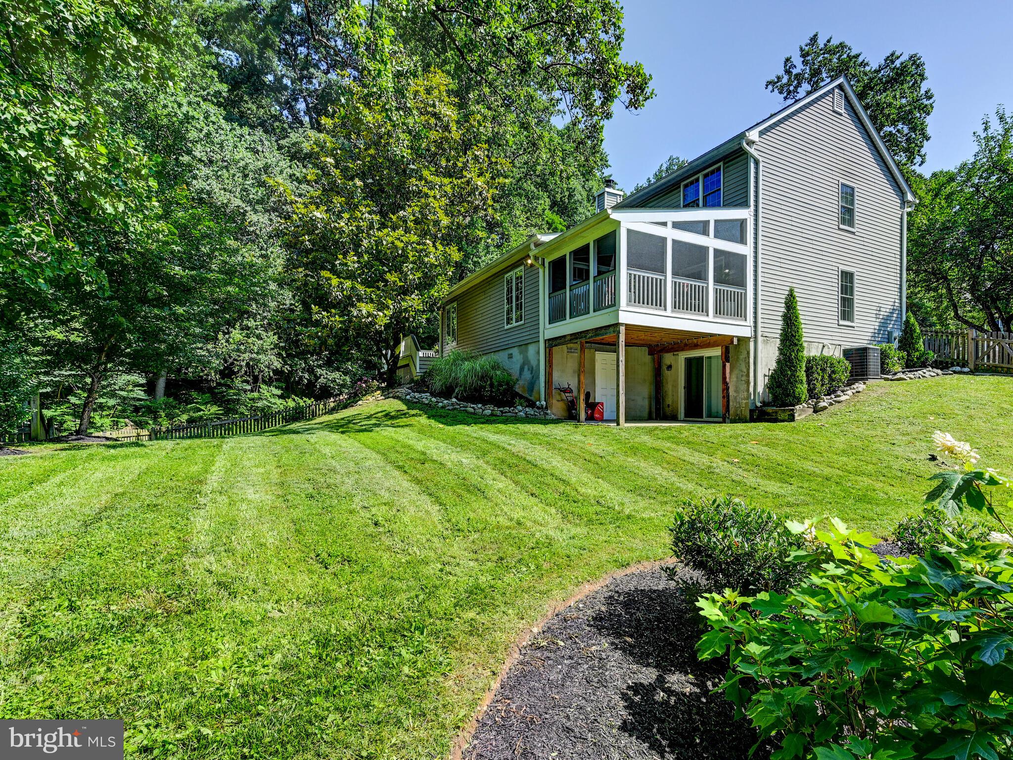 265 Hunters Ridge Road Lutherville-Timonium, MD 21093 - Photo 36 of 42 a front view of a house with a yard and trees