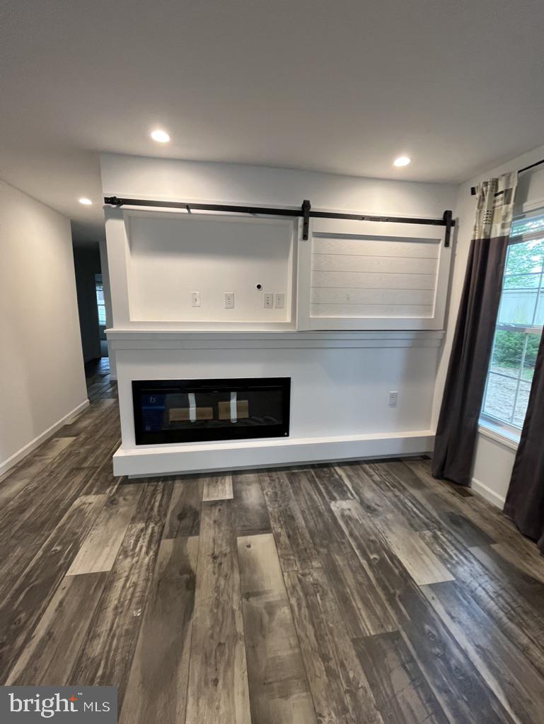 197 Spring Lane Doylestown, PA 18901 - Photo 13 of 17 a view of an empty room with wooden floor and a fireplace