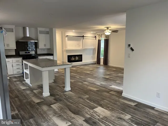 a view of a kitchen with a sink and a fireplace