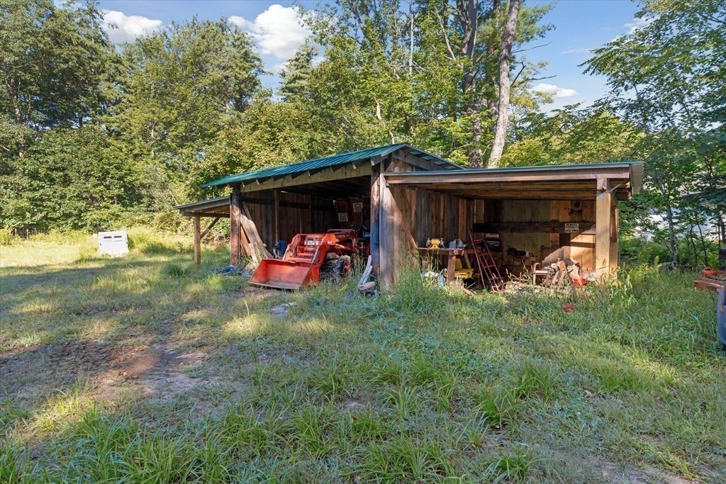 160 Hall Road Winchendon, MA 01475 - Photo 24 of 35 a view of a backyard with table and chairs and a large tree