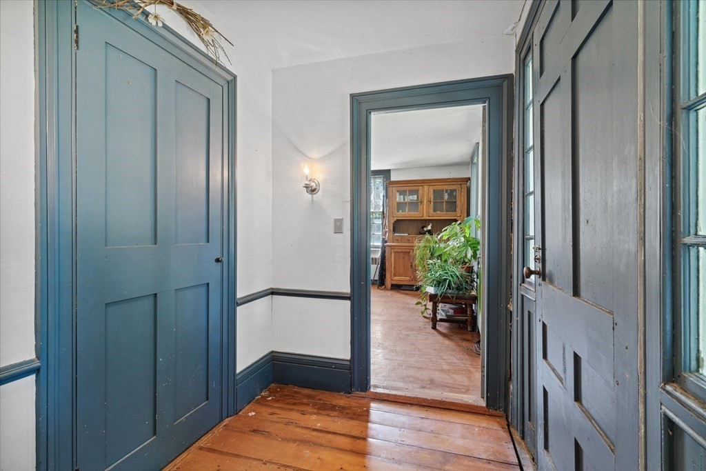 160 Hall Road Winchendon, MA 01475 - Photo 4 of 35 a view of a hallway with wooden floor and a living room