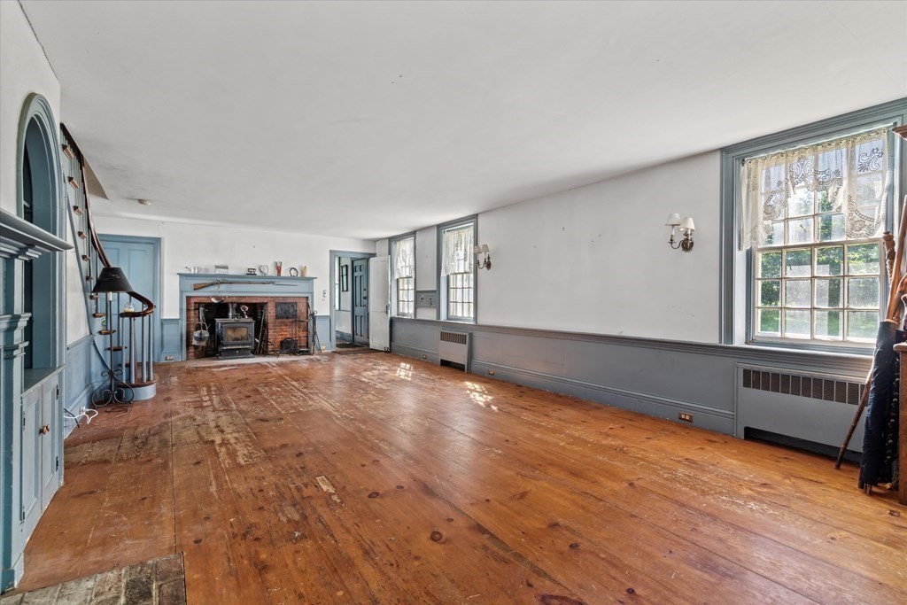 160 Hall Road Winchendon, MA 01475 - Photo 7 of 35 a big room with wooden floor and a fireplace