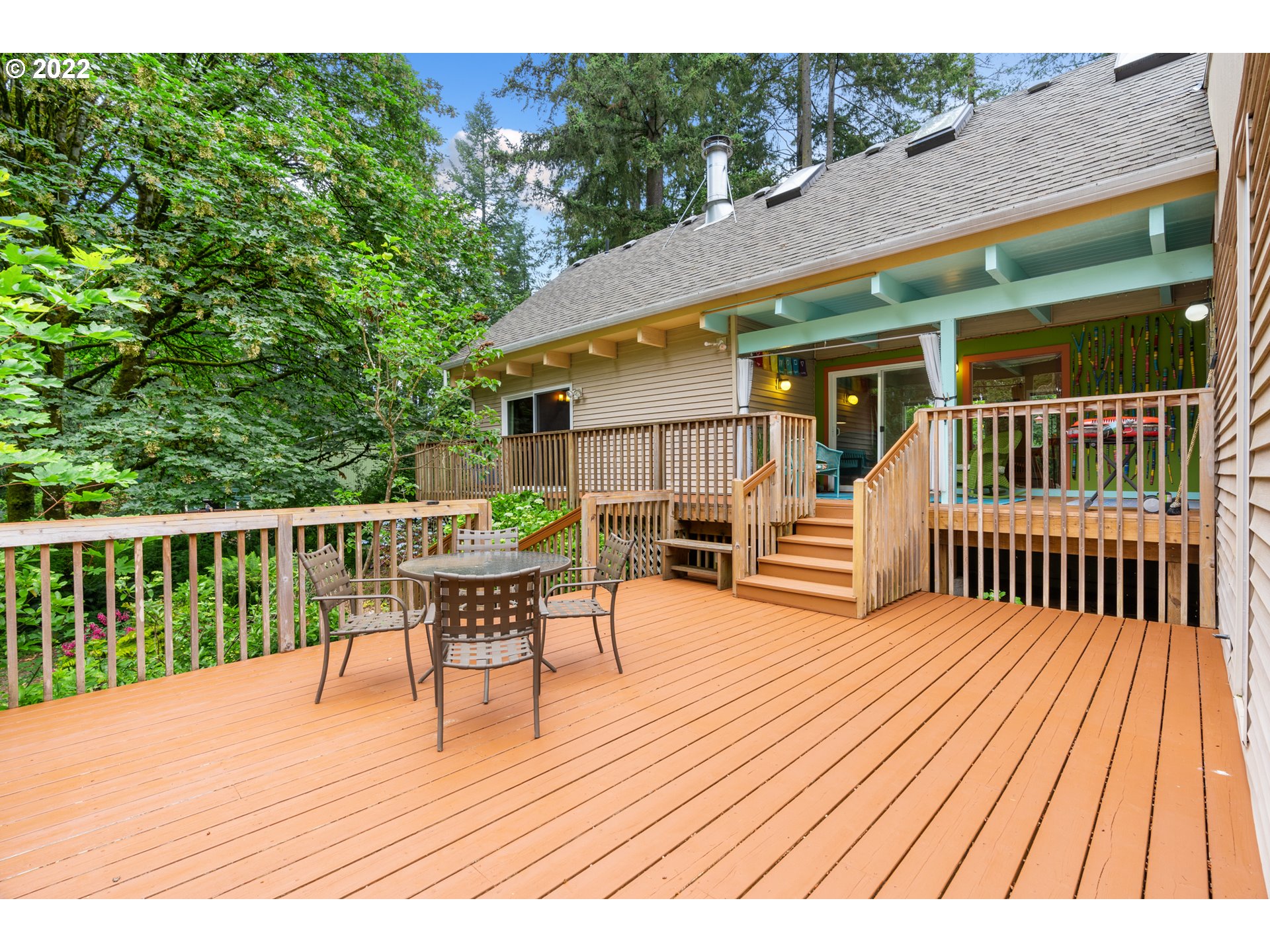 3201 Northwest 199th Street Ridgefield, WA 98642 - Photo 27 of 32 a view of a house with wooden deck and furniture