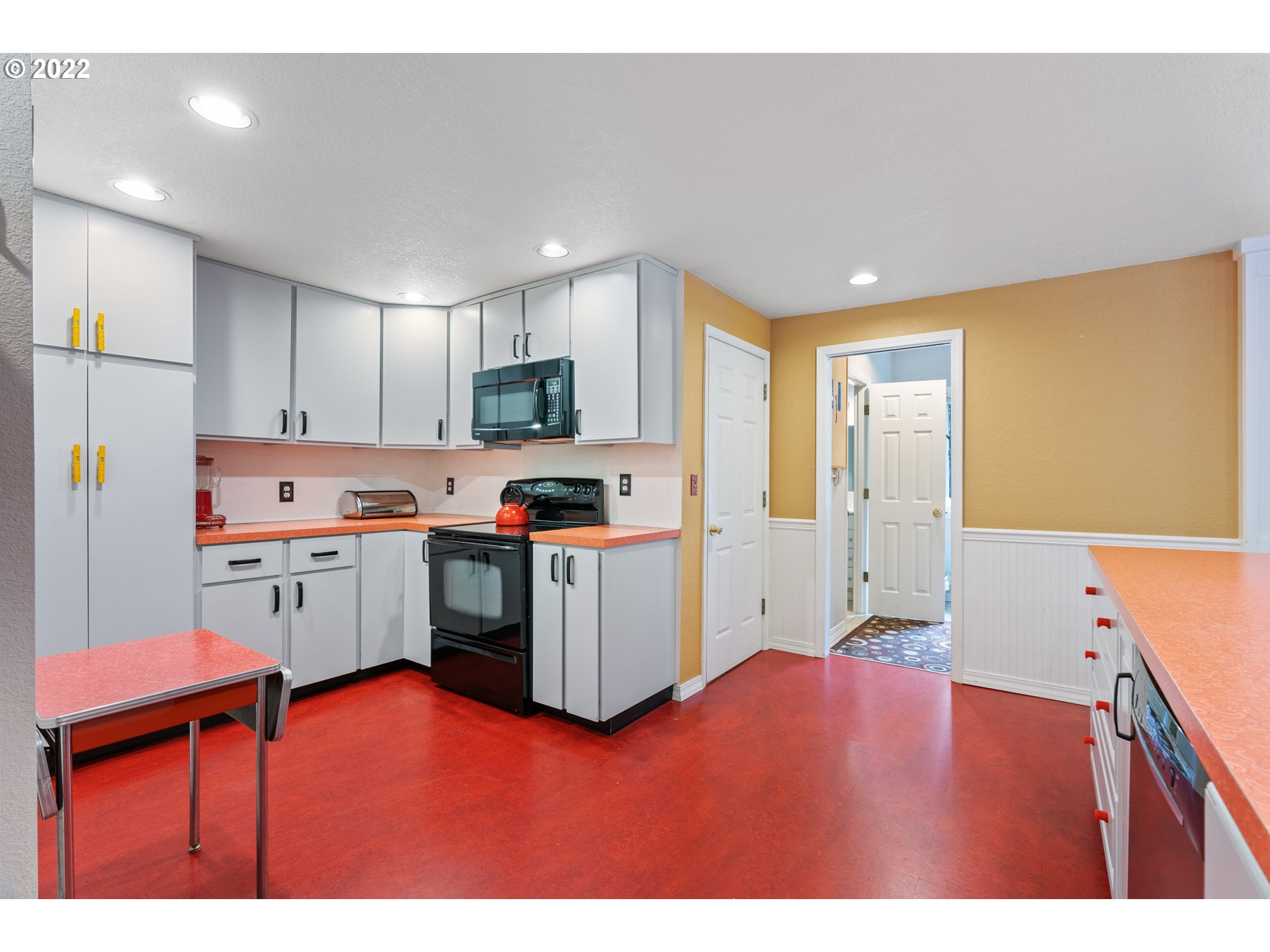 3201 Northwest 199th Street Ridgefield, WA 98642 - Photo 7 of 32 a kitchen with cabinets and wooden floor