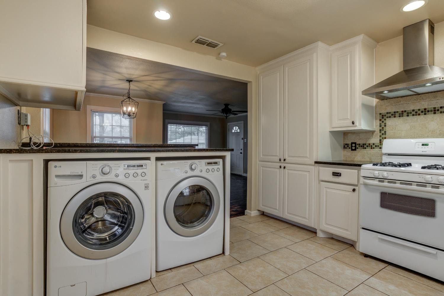 3415 27th Street Lubbock, TX 79410 - Photo 14 of 30 a kitchen with a stove top oven and cabinets