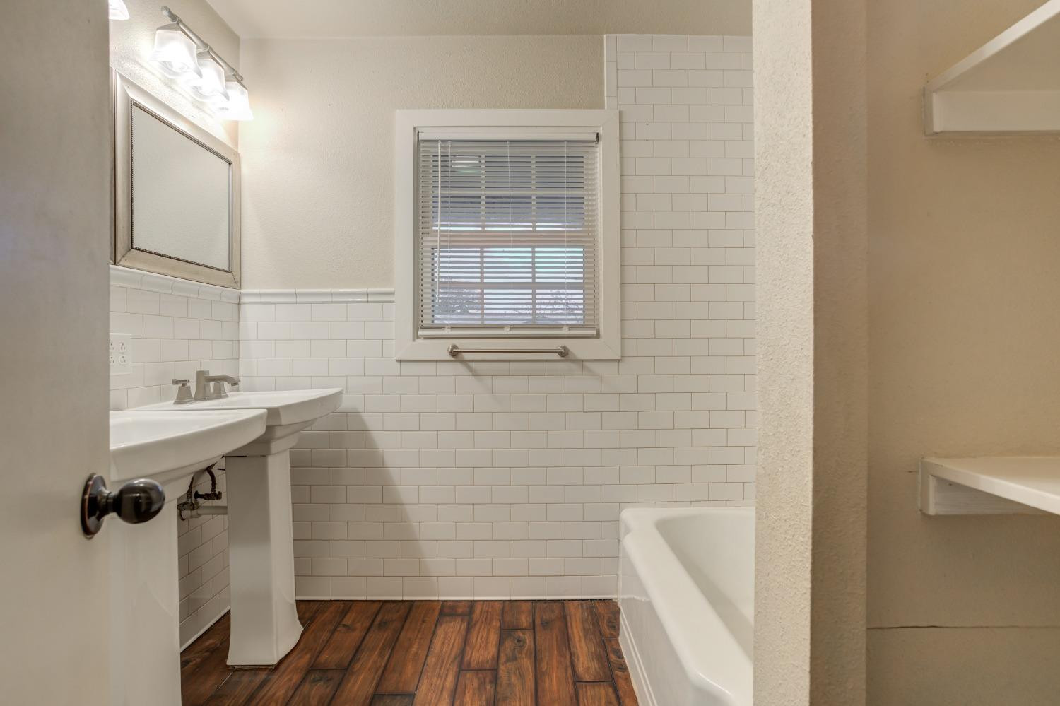 3415 27th Street Lubbock, TX 79410 - Photo 19 of 30 a bathroom with a sink and a window
