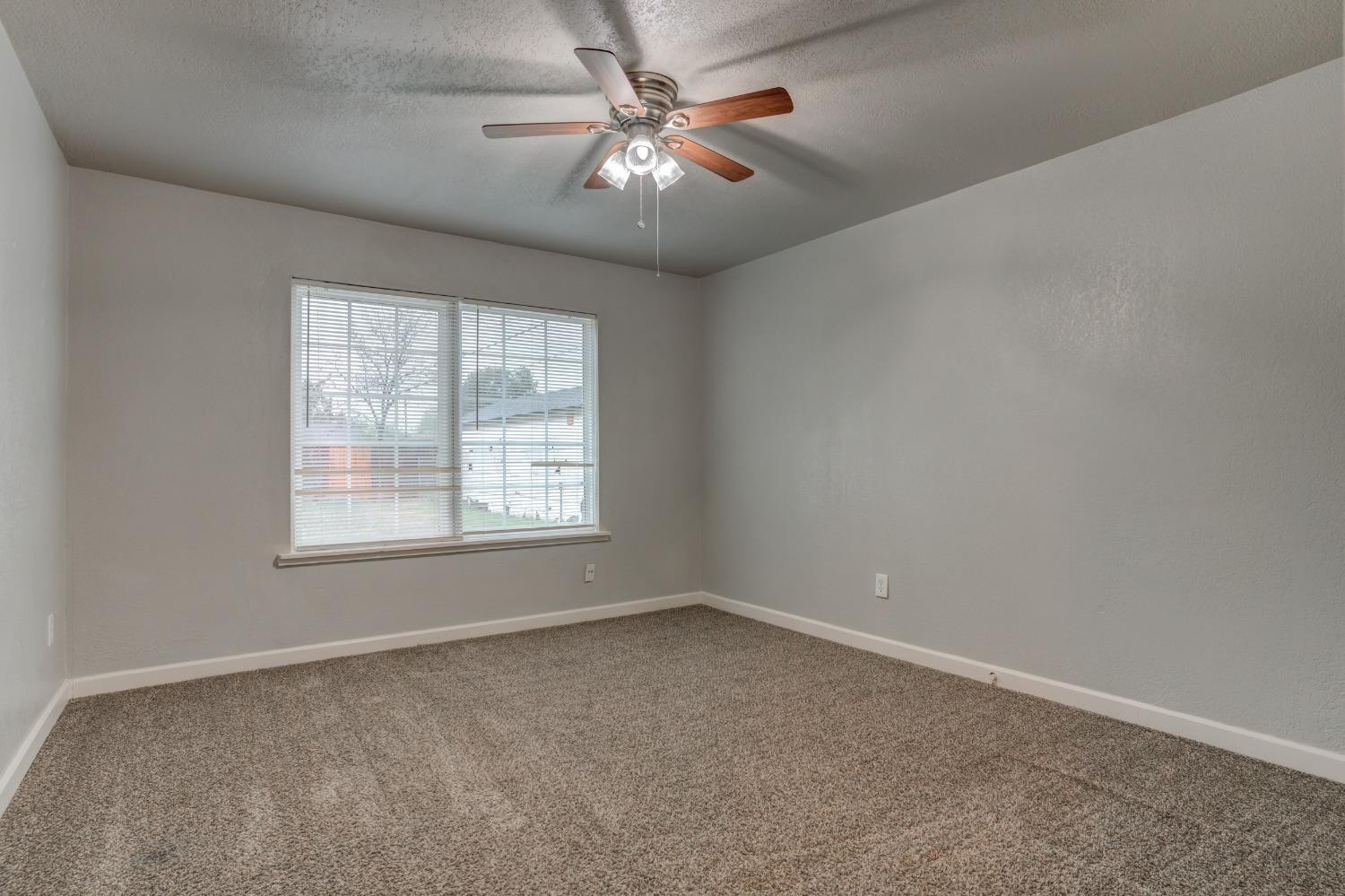 3415 27th Street Lubbock, TX 79410 - Photo 21 of 30 an empty room with windows and fan