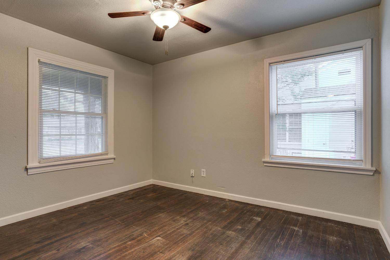 3415 27th Street Lubbock, TX 79410 - Photo 25 of 30 a view of an empty room with wooden floor and a window