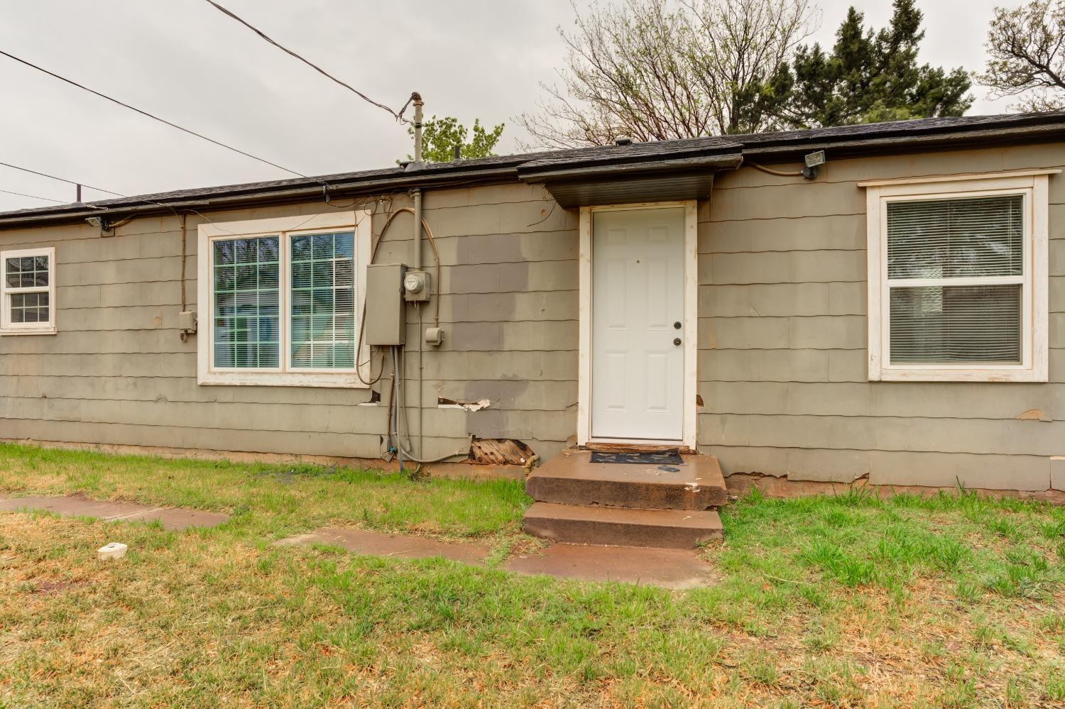 3415 27th Street Lubbock, TX 79410 - Photo 28 of 30 a front view of a house with a yard
