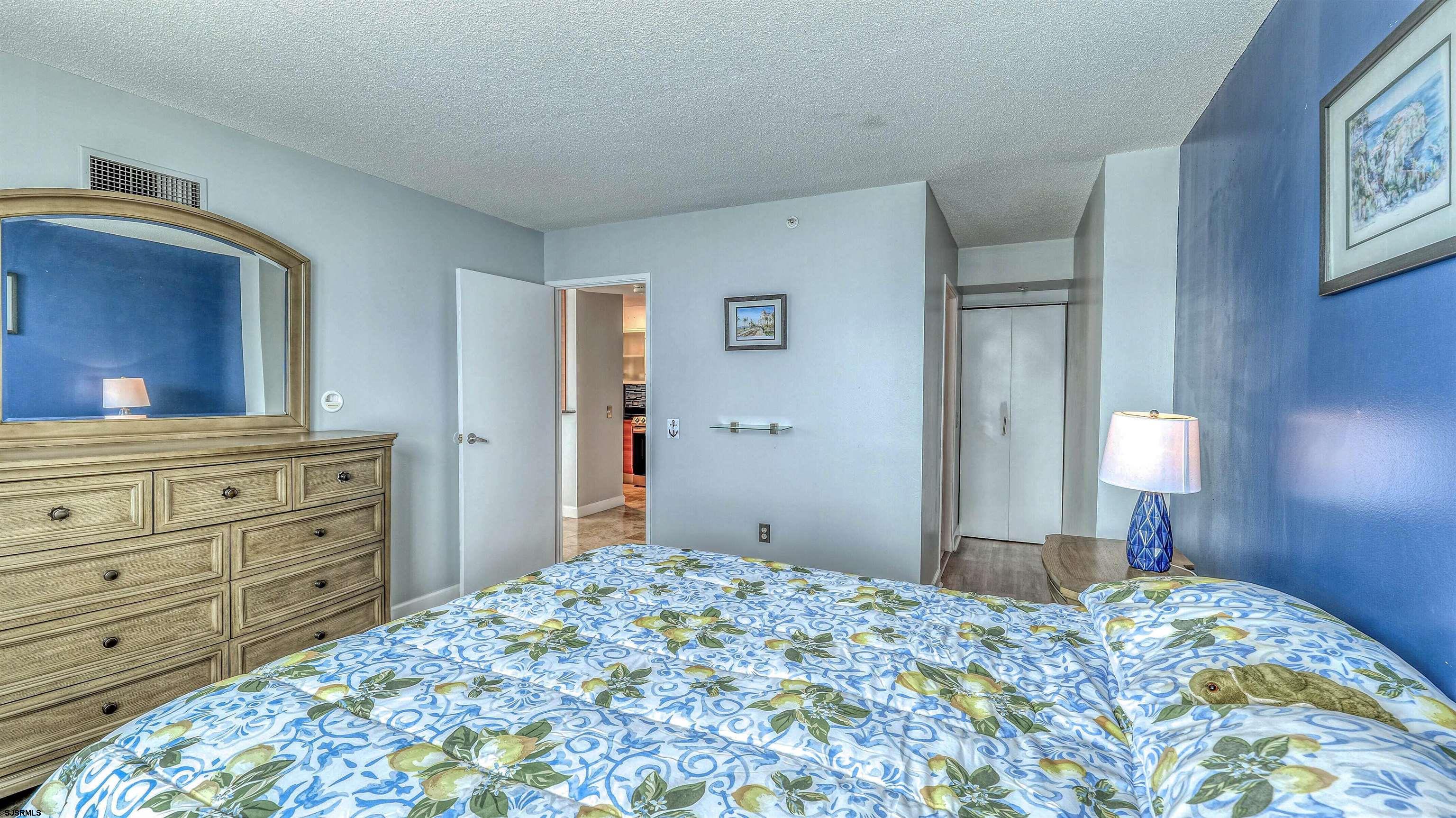 526 Pacific Avenue, Unit 903 Atlantic City, NJ 08401 - Photo 19 of 43 a bedroom with a bed and a mirror on dresser