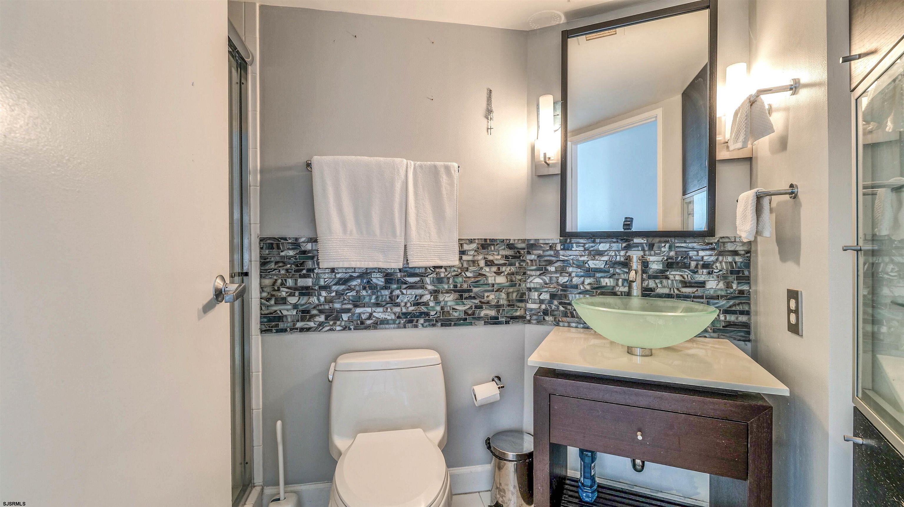 526 Pacific Avenue, Unit 903 Atlantic City, NJ 08401 - Photo 26 of 43 a bathroom with a toilet sink and mirror