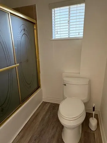 a bathroom with a toilet and a shower
