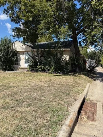 a view of a yard covered with snow in front of house