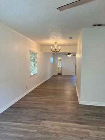 a view of a room with wooden floor