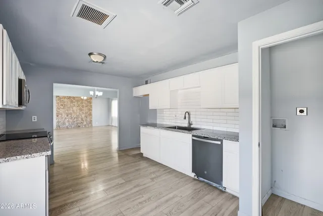 a kitchen with stainless steel appliances granite countertop a stove and a refrigerator