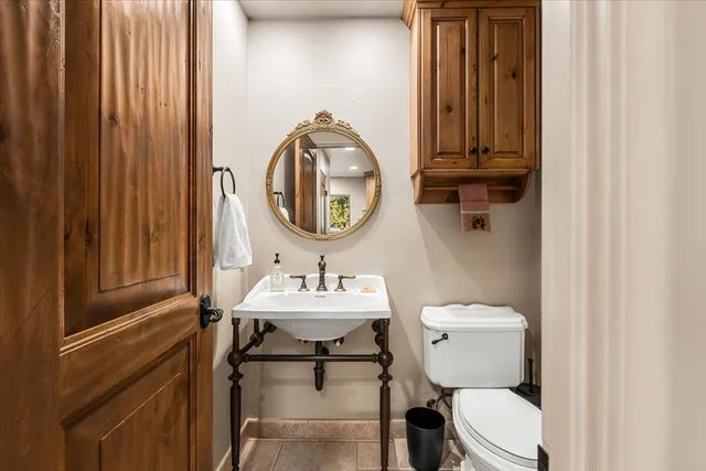a view of a living room with a large window and potted plants