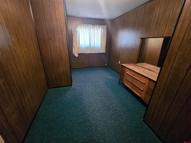 a bedroom with furniture and a mirror