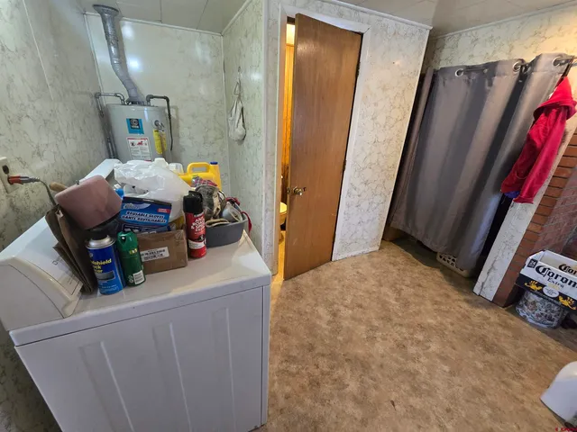a white toilet sitting next to a sink and vanity