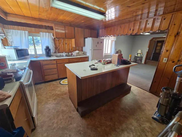 a living room with furniture a flat screen tv and a sink