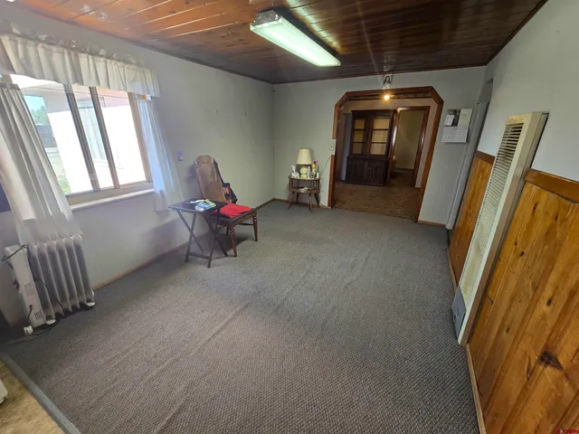 a view of a livingroom with hardwood floor and a ceiling fan