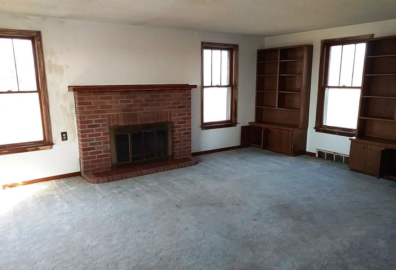 4287 South Freeport Road Polo, IL 61064 - Photo 3 of 11 an empty room with windows and fireplace