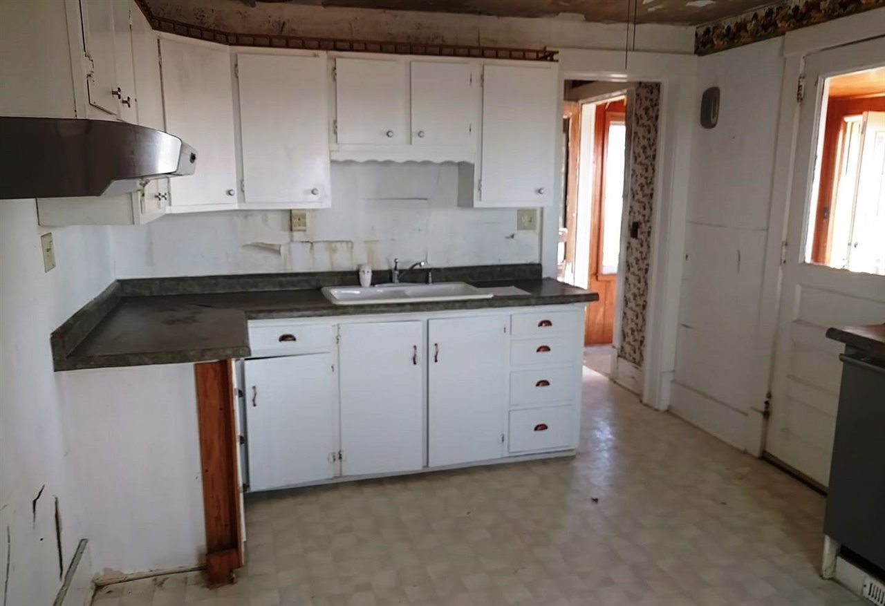 4287 South Freeport Road Polo, IL 61064 - Photo 4 of 11 a kitchen with granite countertop white cabinets and sink