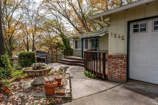a view of a chair and tables back yard of the house