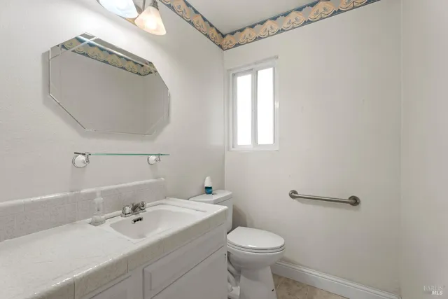 a bathroom with a sink a toilet and mirror