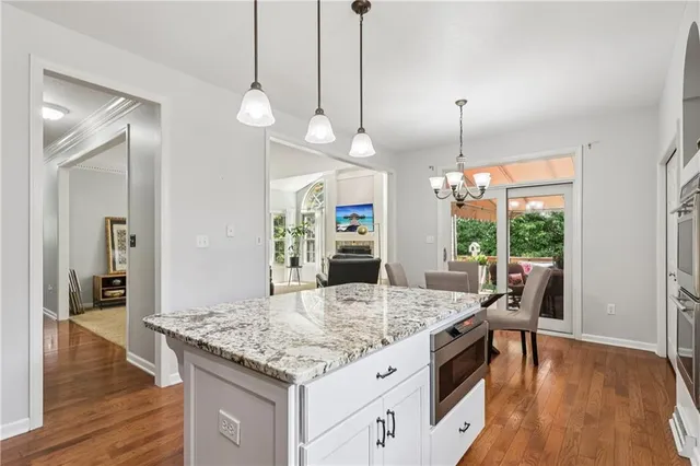 a view of washer and dryer with bathroom in the background