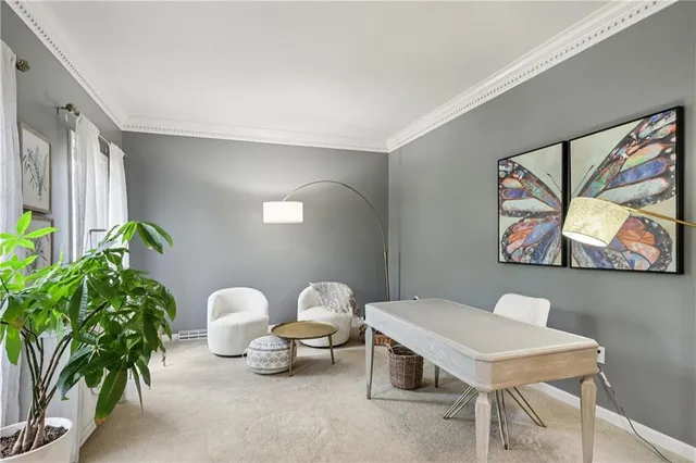 a living room with furniture a fireplace and a chandelier