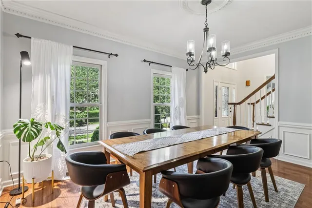 a kitchen with stainless steel appliances granite countertop a refrigerator a sink dishwasher a kitchen island with wooden floor and cabinets