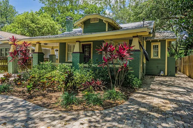 a view of a house with potted plants