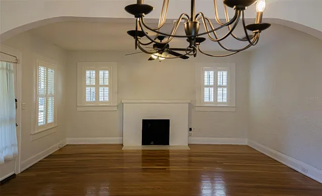 a view of a livingroom with wooden floor and a window