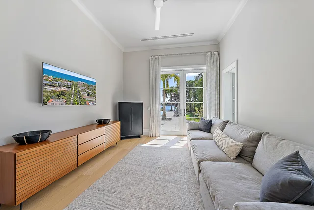 a spacious bedroom with a bed and wooden floor