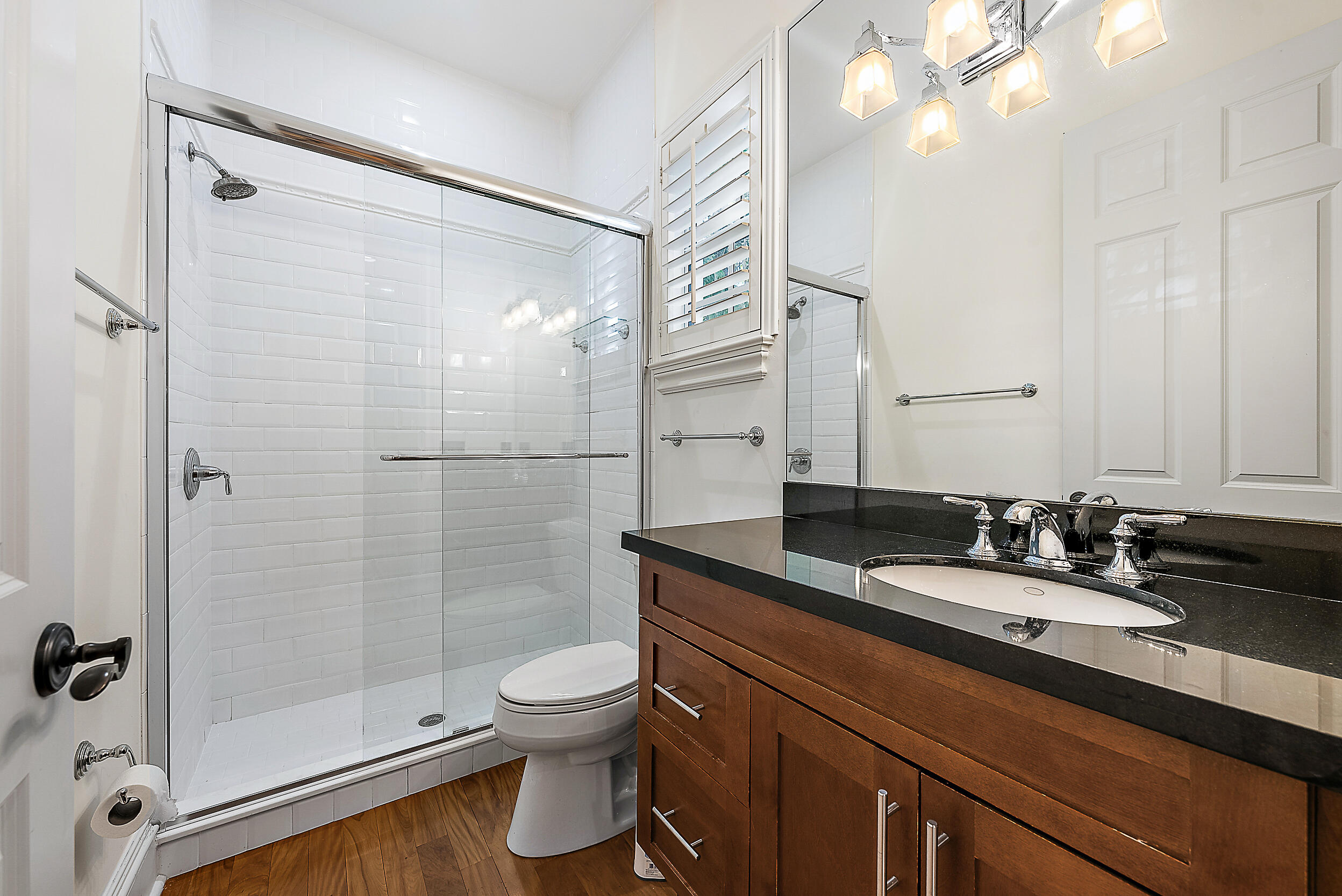 19651 North Riverside Drive Jupiter, FL 33469 - Photo 27 of 37 a bathroom with a double vanity sink toilet and shower